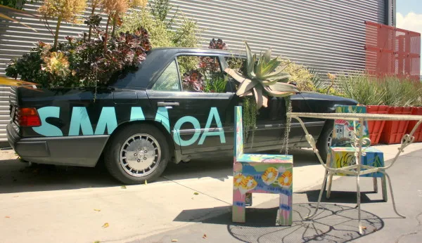 A car-turned-planter sits in the courtyard outside the entrance to the Santa Monica Museum of Art (Photo by Jason Islas)