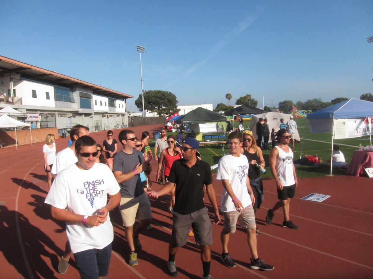 A large group takes a lap around the track at Corsair Field at Santa Monica College Saturday as part of this weekend’s Relay for Life fundraiser.