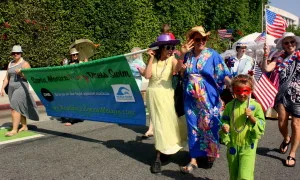 Volunteers from the Church in Ocean Park march along in fancy dresses raising awareness of -- and money to combat -- malaria in Africa. (Photo by Jason Islas)