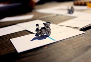 A miniature train holds cards down to prevent them from being blown away by the wind.