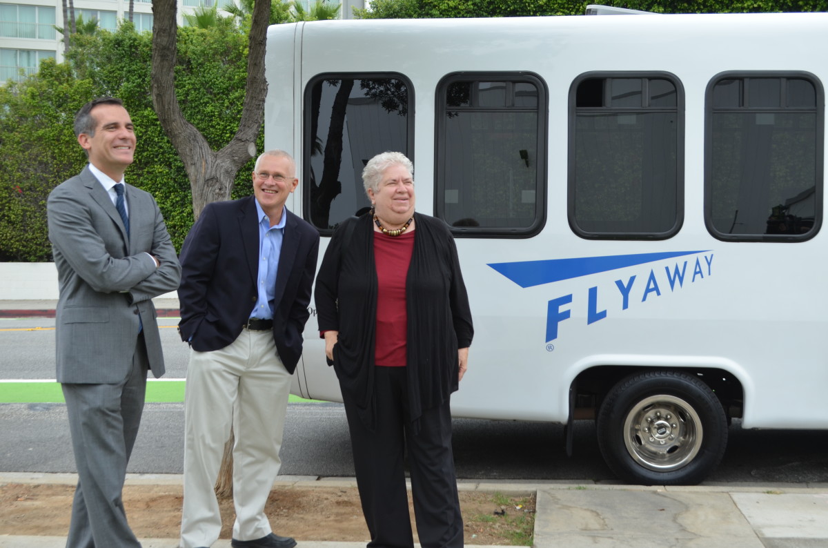 Santa Monica Mayor Pam O'Connor, L.A. Mayor Eric Garcetti, and L.A. Councilmember Mike Bonin gather in front of a FlyAway bus by the Santa Monica Civic Center Monday (photos by David Graham-Caso)