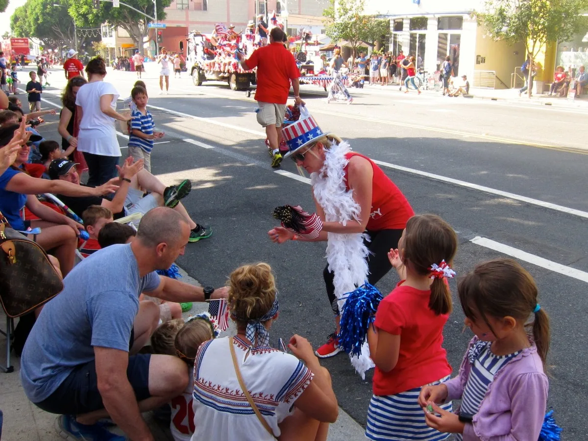 Small American flags are handed out along the parade route for Santa Monica’s Fourth of July celebration on Main Street Friday. (Photo by Saul Rubin)