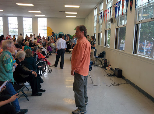 SMRR co-founder Denny Zane stands in front of the crowd at John Adams Middle School at the 2014 SMRR endorsement convention.