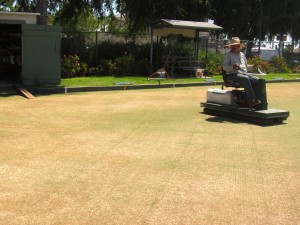 Jose Mendoza uses a special machine to roll the lawn bowling green and keep it in perfect playing condition at the Santa Monica Lawn Bowls Club at Douglas Park.