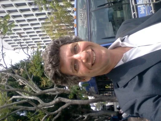 Scott Schultz, host of BUSted!, poses in front of a Big Blue Bus. His public transit-themed storytelling show will make its Santa Monica debut Thursday.
