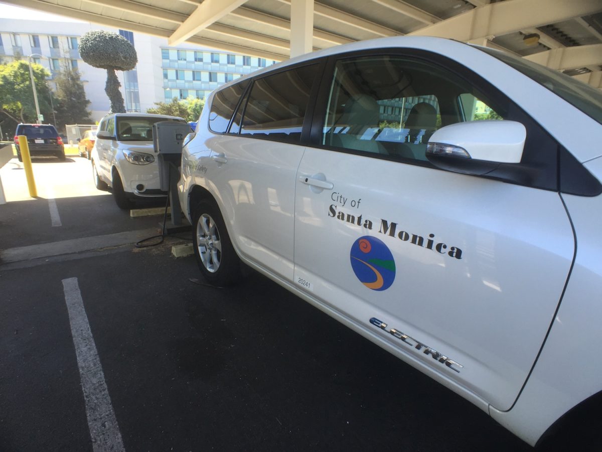 Two city-owned electric vehicles are recharged at the Civic Center station. The city’s climate change report cited the use of cleaner energy as one way the city is reducing its carbon footprint.