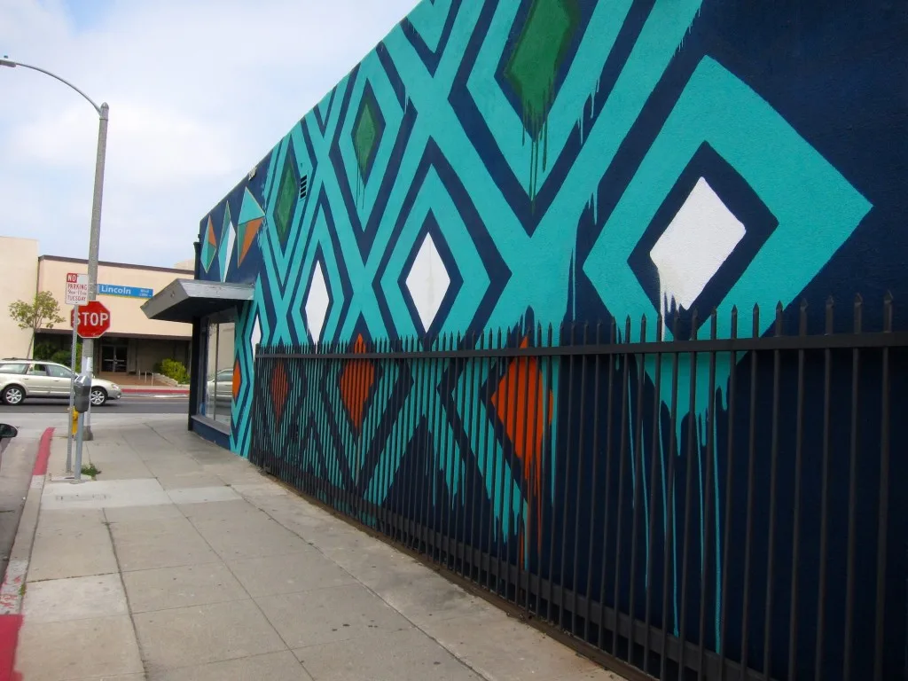 This mural on the side wall of the Printing Palace on Lincoln Boulevard has generated attention, according to the store manager, but not done much to improve business.
