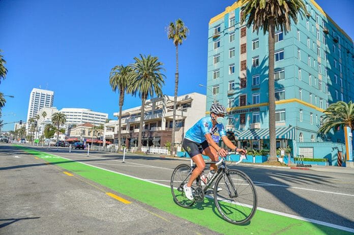 Man Biking in Ocean Ave Bikeay in front of Georgian Hotel (800x532)